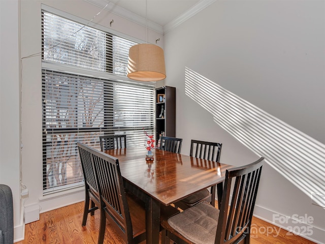 dining room with ornamental molding and hardwood / wood-style floors