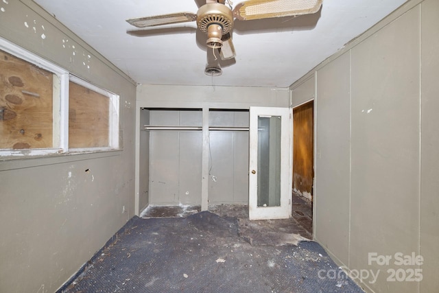 unfurnished bedroom featuring two closets and ceiling fan