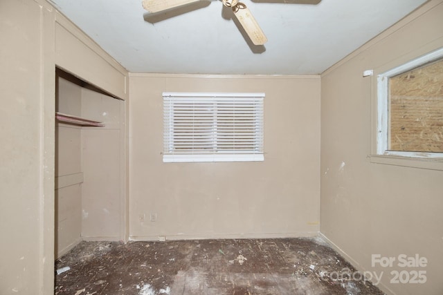 unfurnished bedroom with ceiling fan and a closet