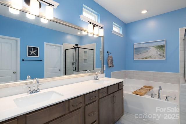 bathroom featuring plus walk in shower and vanity