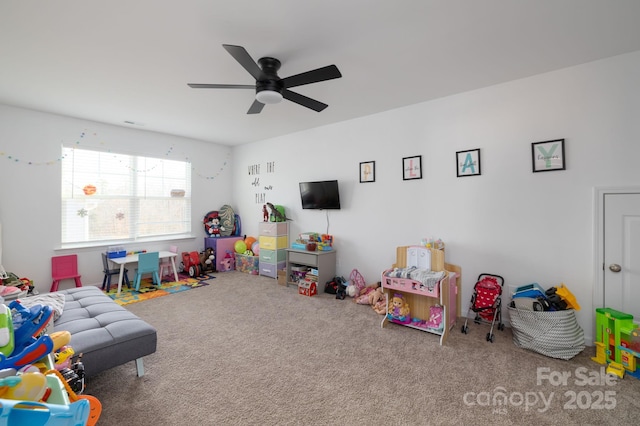 playroom featuring ceiling fan and carpet