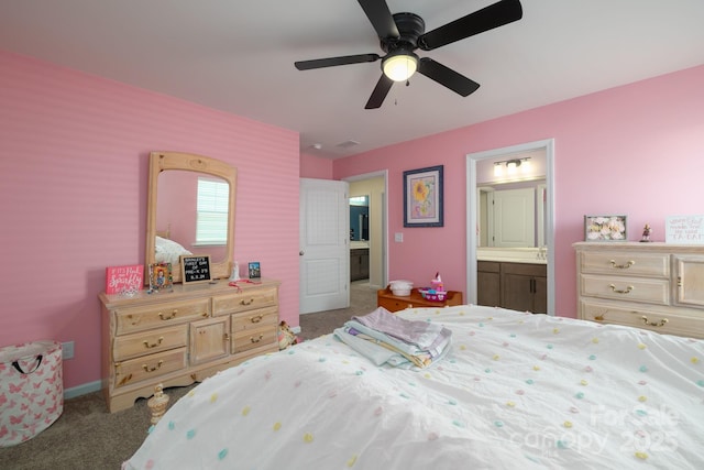 bedroom with ceiling fan, ensuite bathroom, and carpet floors