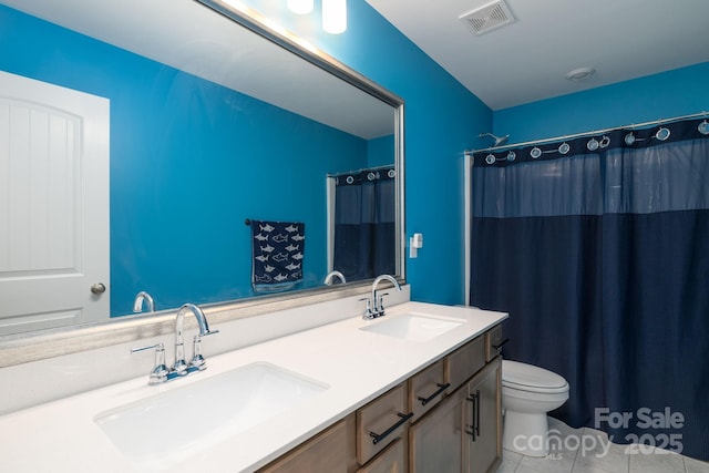 bathroom featuring a shower with curtain, tile patterned floors, vanity, and toilet