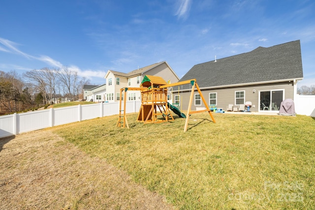 view of yard featuring a playground and a patio