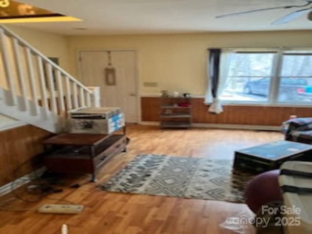 living room featuring ceiling fan and light hardwood / wood-style floors