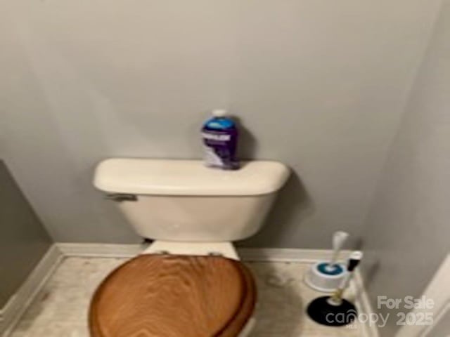 bathroom with toilet and tile patterned flooring