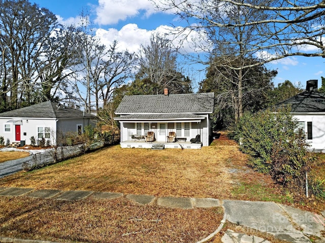 exterior space with covered porch and a front lawn