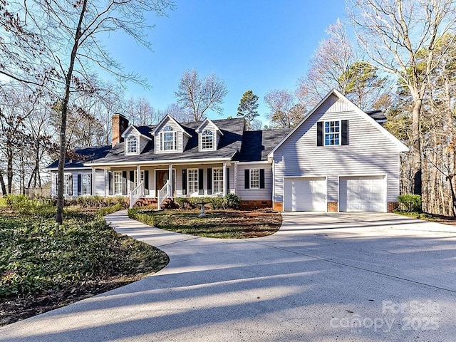 cape cod home with a garage and a porch