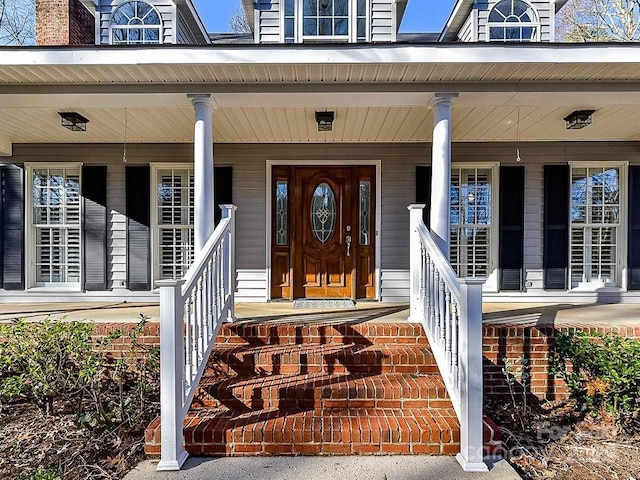 entrance to property featuring covered porch