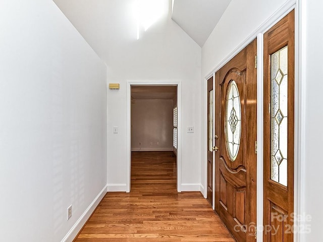 entryway featuring vaulted ceiling and light hardwood / wood-style floors