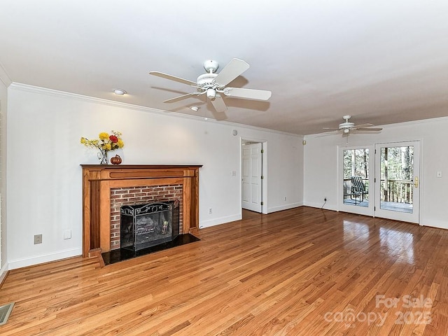 unfurnished living room with ceiling fan, ornamental molding, a fireplace, and light wood-type flooring