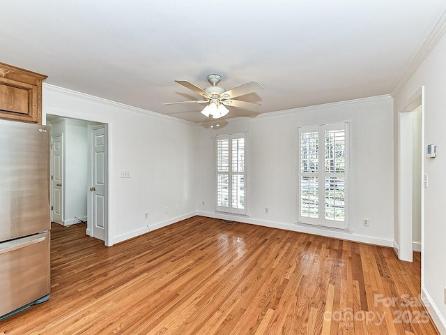 unfurnished room featuring crown molding, ceiling fan, and light hardwood / wood-style flooring