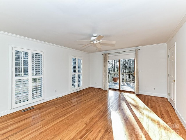 spare room featuring ceiling fan, ornamental molding, and light hardwood / wood-style floors