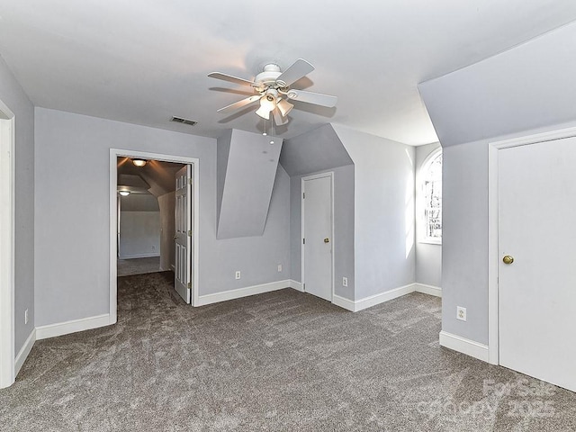 bonus room with dark colored carpet, vaulted ceiling, and ceiling fan