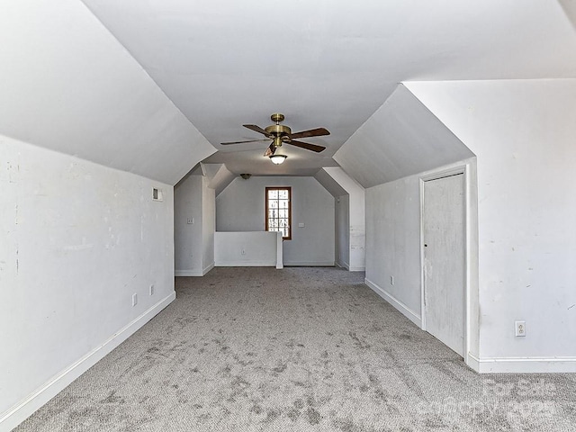 bonus room featuring lofted ceiling, light colored carpet, and ceiling fan