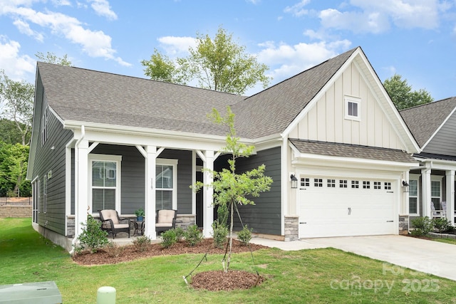 craftsman-style home featuring a garage, a front yard, and covered porch