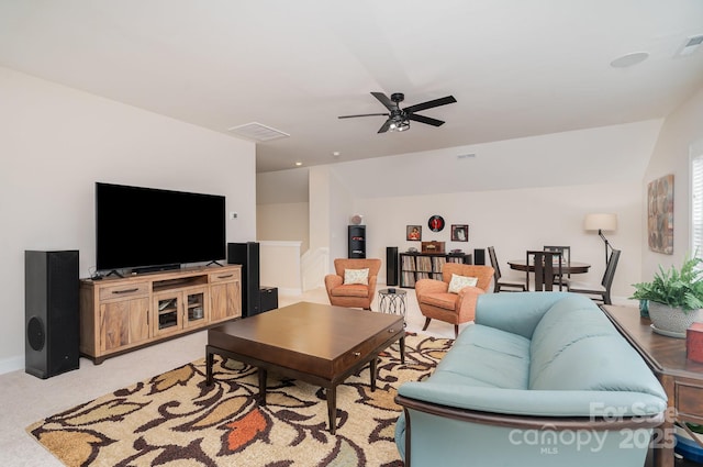 carpeted living room with ceiling fan