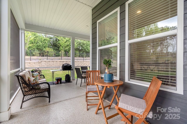 sunroom featuring a healthy amount of sunlight and wood ceiling