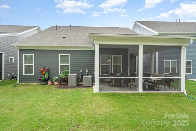 rear view of property featuring central AC unit, a patio area, and a lawn