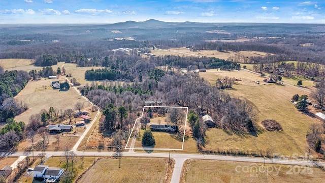 drone / aerial view featuring a mountain view and a rural view