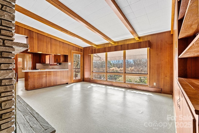 interior space with vaulted ceiling with beams and wood walls