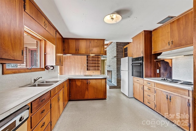 kitchen featuring white appliances and sink