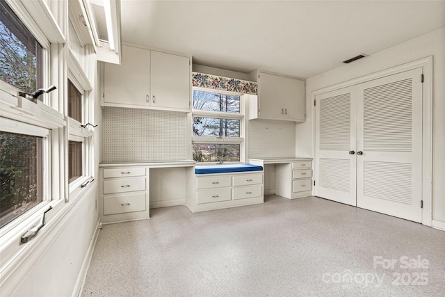 kitchen featuring white cabinetry and decorative backsplash