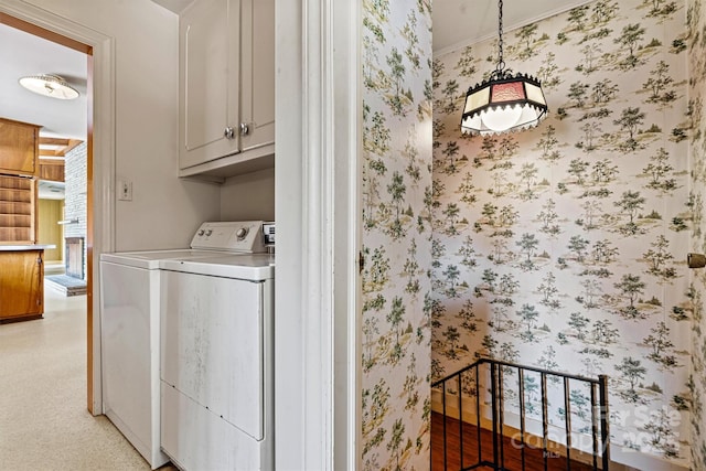 laundry area featuring separate washer and dryer and cabinets