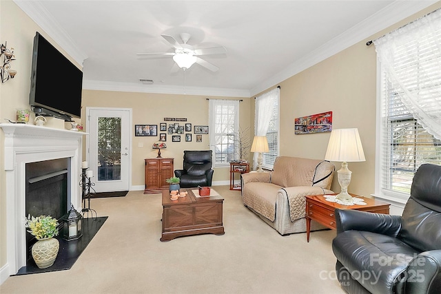 living room with crown molding, light colored carpet, and ceiling fan