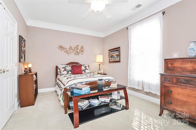 carpeted bedroom with ornamental molding and ceiling fan