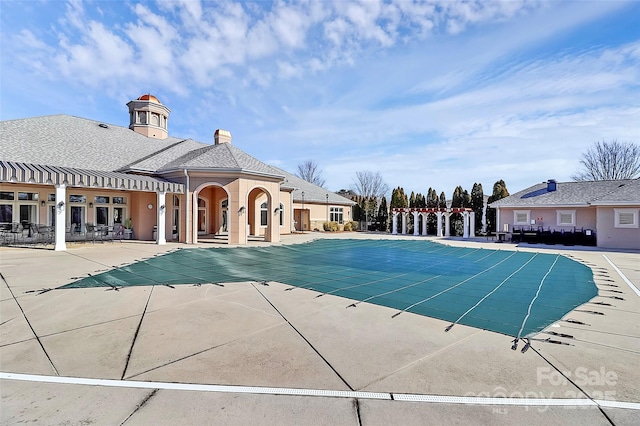 view of swimming pool with a patio