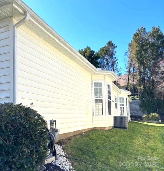 view of property exterior with a lawn