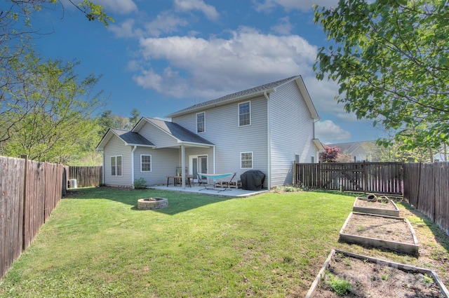 rear view of house with an outdoor fire pit, a patio area, and a lawn