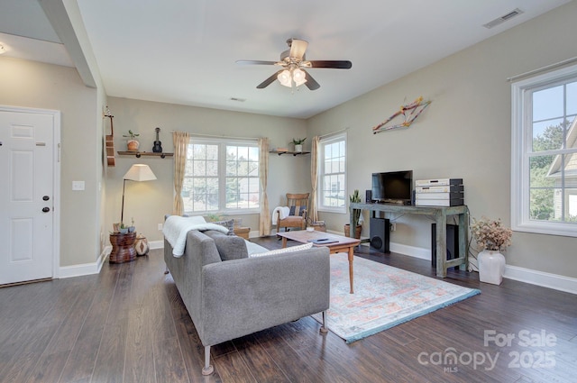 living room with dark hardwood / wood-style flooring, a fireplace, and ceiling fan