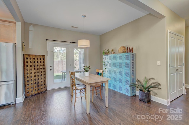 dining space featuring dark wood-type flooring