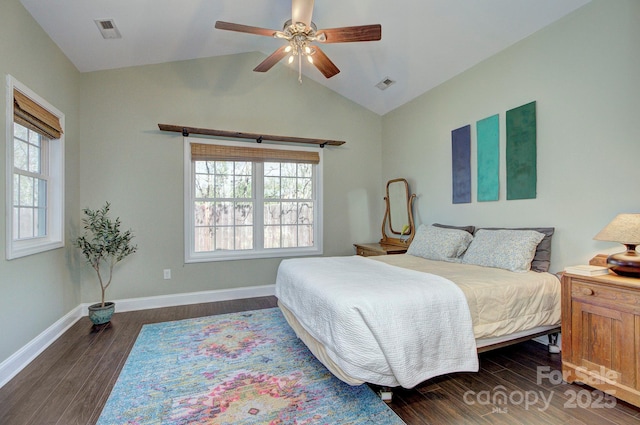 bedroom featuring multiple windows, lofted ceiling, and dark hardwood / wood-style floors