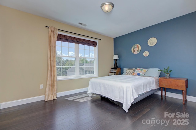 bedroom with dark wood-type flooring