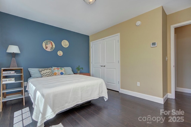 bedroom featuring a closet and dark hardwood / wood-style floors