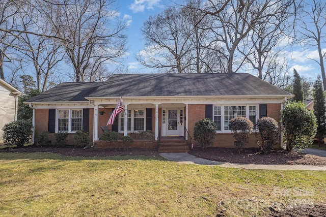 ranch-style home with covered porch and a front lawn