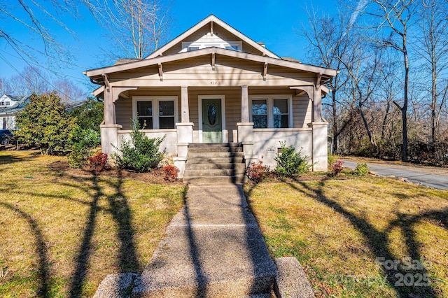 bungalow-style home featuring a front lawn and a porch