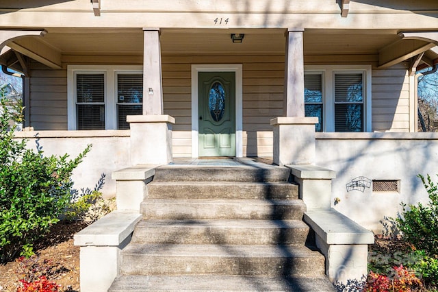 entrance to property featuring a porch