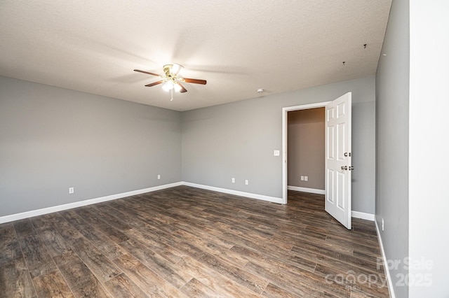 empty room featuring ceiling fan, dark hardwood / wood-style flooring, and a textured ceiling