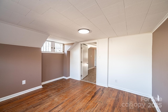 additional living space featuring dark hardwood / wood-style flooring