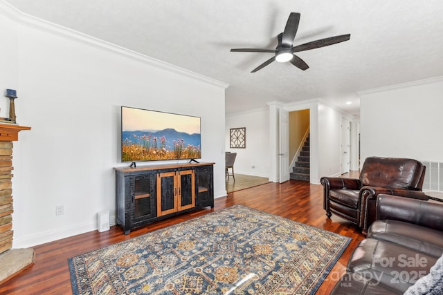 living room featuring ornamental molding, dark hardwood / wood-style floors, and ceiling fan