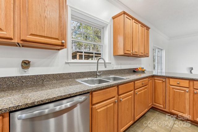 kitchen featuring dishwasher, sink, dark stone counters, ornamental molding, and light tile patterned floors