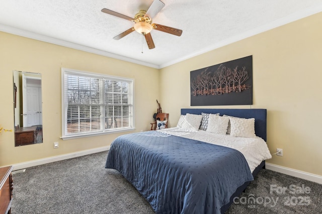 bedroom featuring dark colored carpet, ornamental molding, ceiling fan, and a textured ceiling