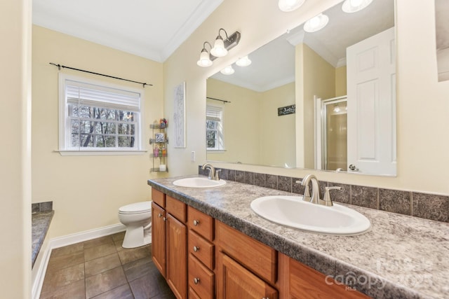 bathroom with crown molding, vanity, tile patterned floors, and walk in shower