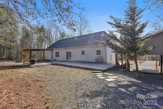 rear view of property featuring a wooden deck