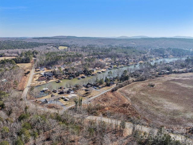 drone / aerial view featuring a water and mountain view