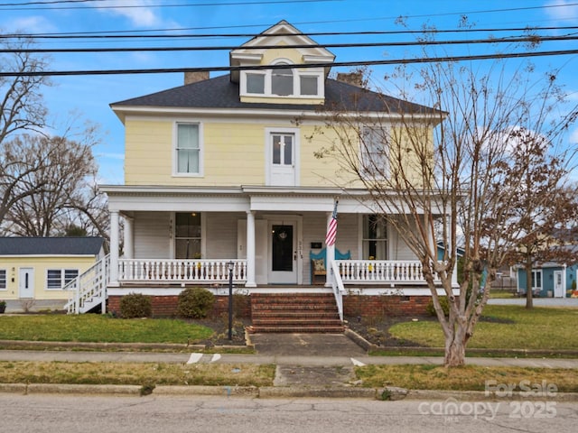 traditional style home with a front lawn and a porch